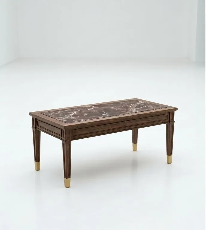 Rectangular walnut coffee table with an inset Rosso Levanto top and brass sabots, photographed against a plain white wall.